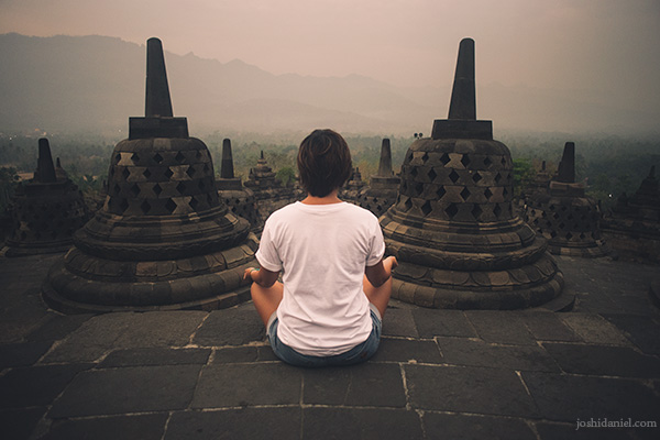 Gemala Hanafiah sitting in a meditative pose in Borobudur, Indonesia